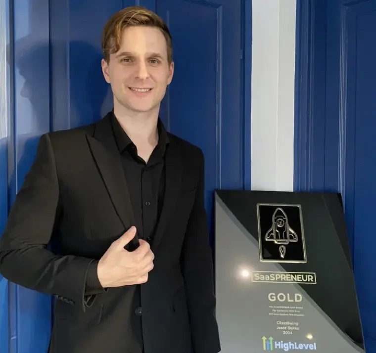 Jesse Danku, CEO and founder of ClientSwing, holding the HighLevel Gold award
